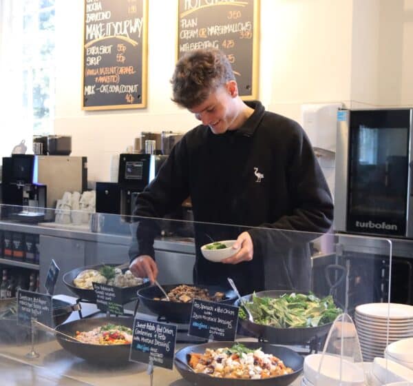 A man serving salads in Holkham Courtyard Cafe