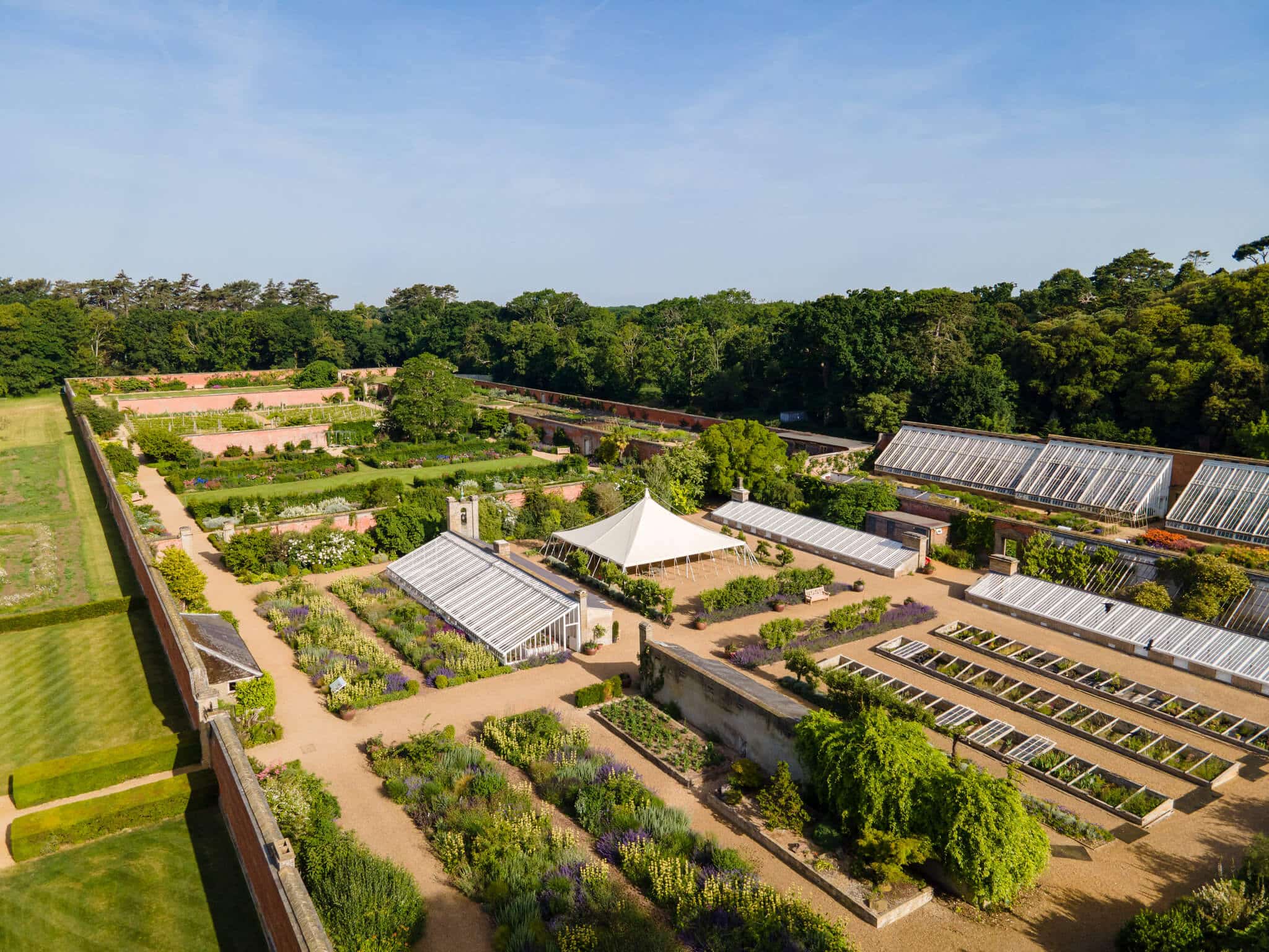 An aerial photograph of Holkham Walled Garden, showing the different rooms, glasshouses, and beds.