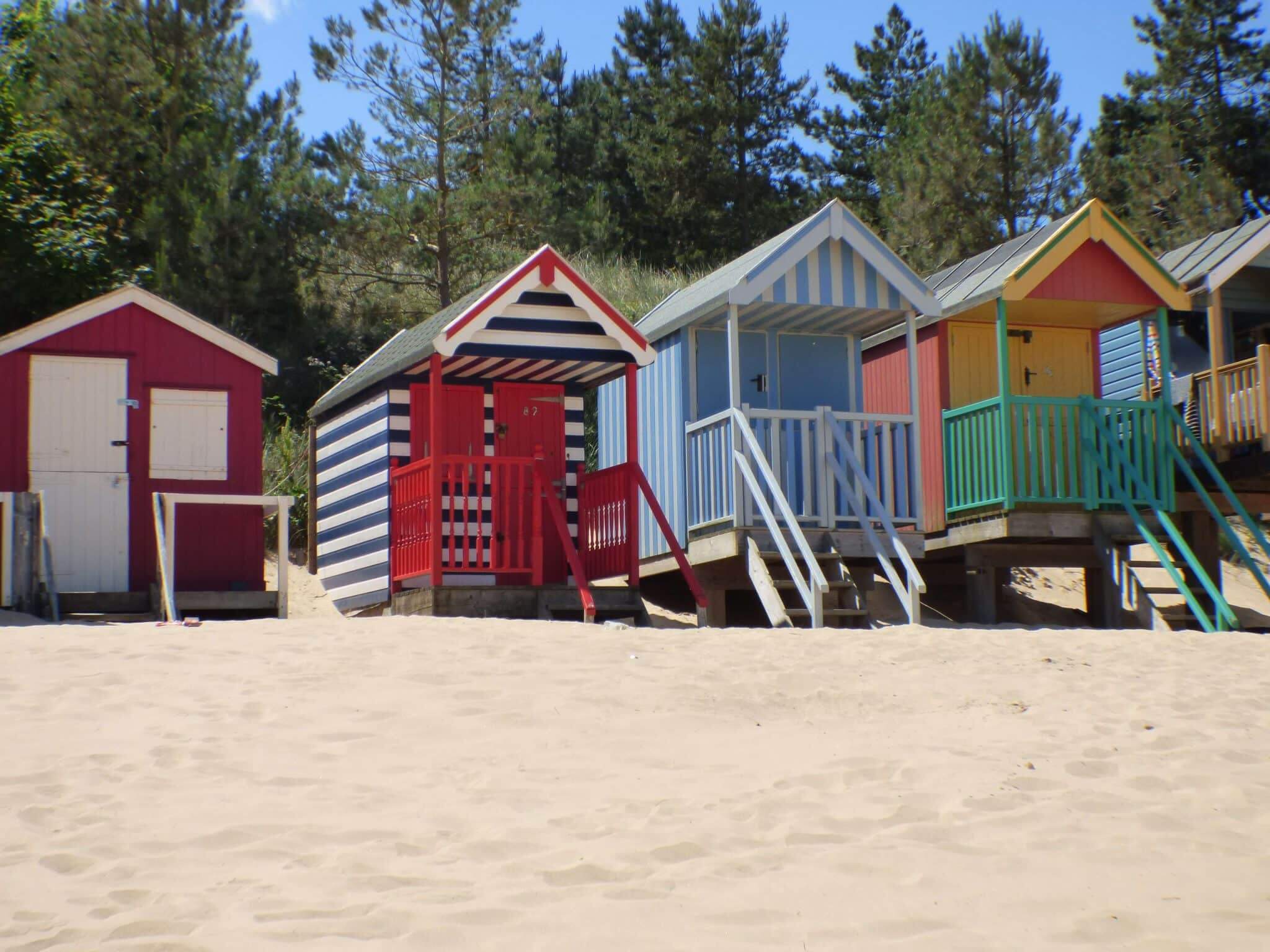 Five colourful beach huts on Wells Beach