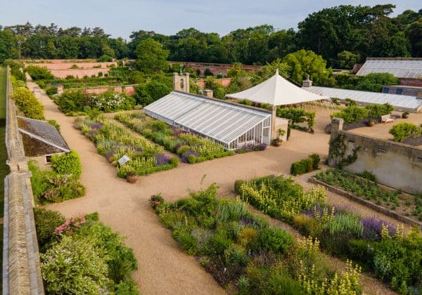 Aerial shot showing neat beds and a glasshouse in Holkham Walled Garden
