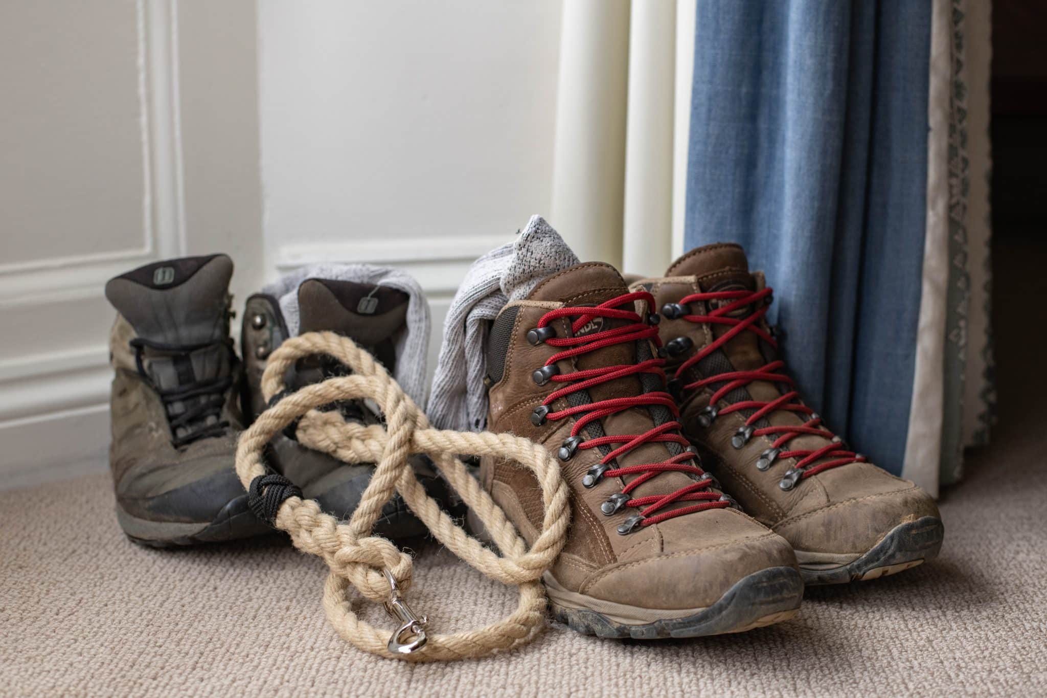 Two pairs of walking boots and a rope dog lead