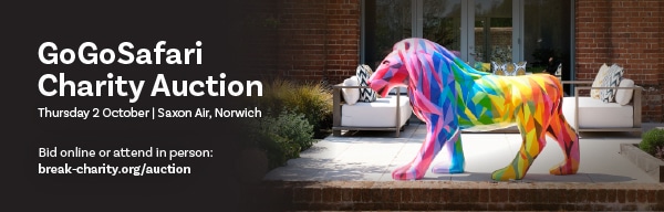 GoGo Safari Auction banner featuring a rainbow lion sculpture.