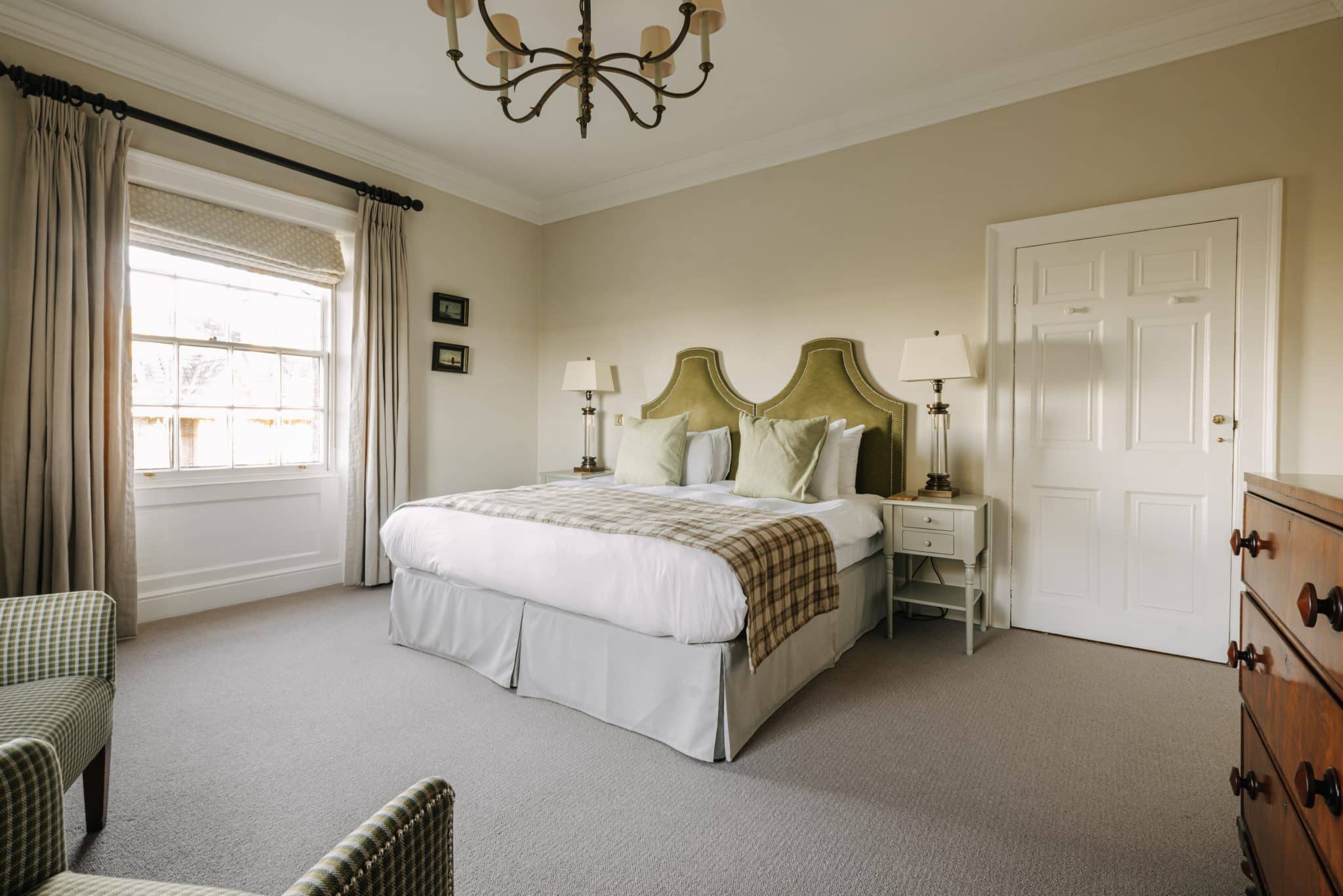 A king bed in a spacious hotel room
