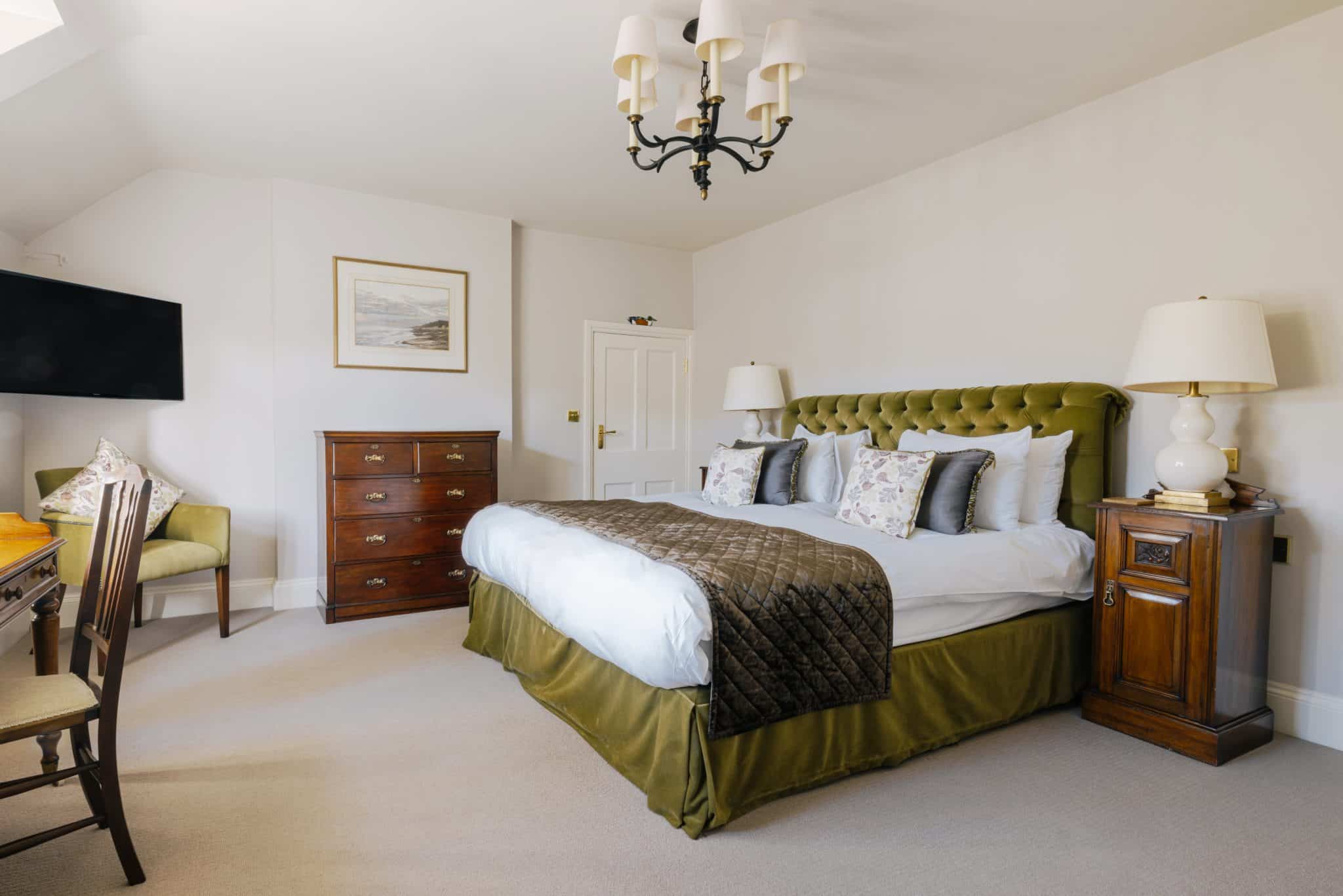 A king bed in a spacious hotel room