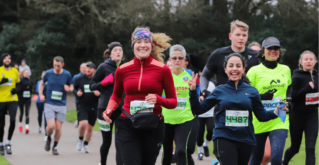 Runners smiling during a run through half marathon