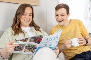 couple reading a magazine in their pinewoods caravan