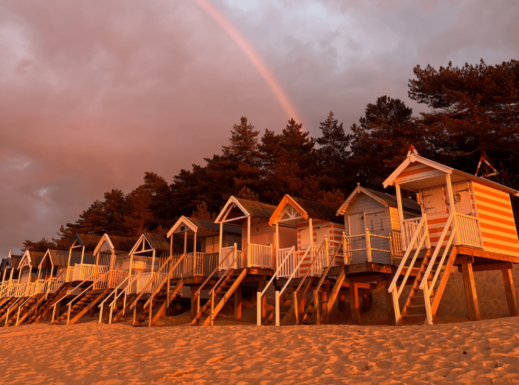 sunset over wells beach huts